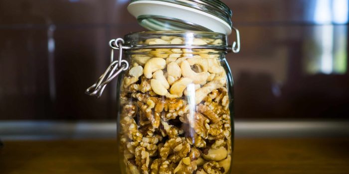 Close-up Of Dry Fruits In Glass Jar On Table At Home